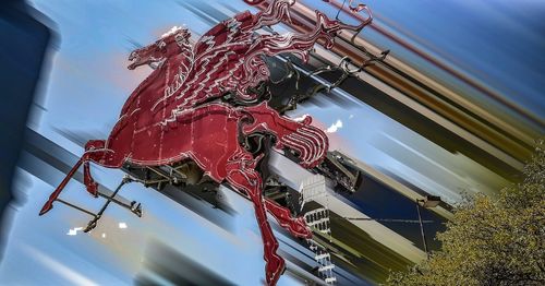 Low angle view of ferris wheel against sky