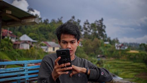 Portrait of young man photographing