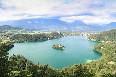 High angle view of lake and mountains against sky