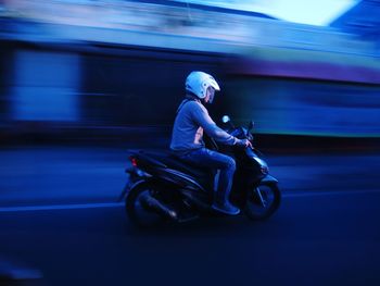 Side view of woman riding motorcycle