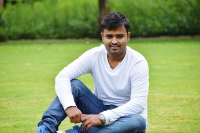 Portrait of young man sitting outdoors