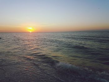 Scenic view of sea against clear sky during sunset