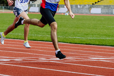 Low section of man playing soccer