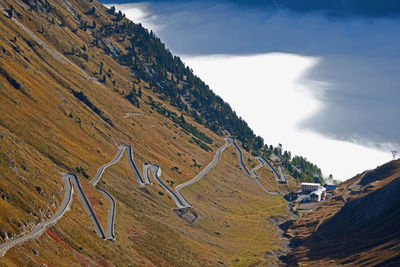 Curved road on mountain against sky