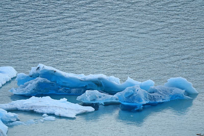 High angle view of iceberg floating on water in sea