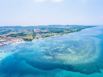 Aerial view of sea against blue sky