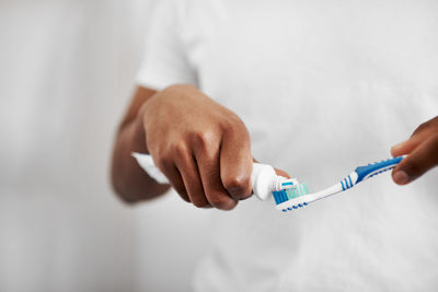 Midsection of doctor holding syringe