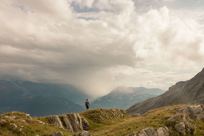 People on mountain against sky