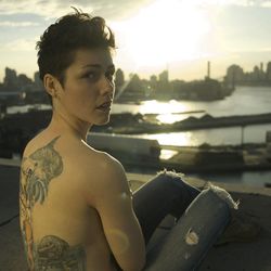 Portrait of young man looking away against sky during sunset