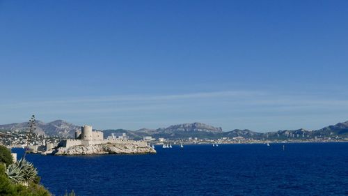 Scenic view of sea against clear blue sky