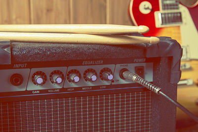 Close-up of drumsticks on amplifier