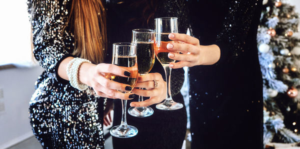 Web banner cheers, toast with champagne. friends celebrating christmas or new year eve party