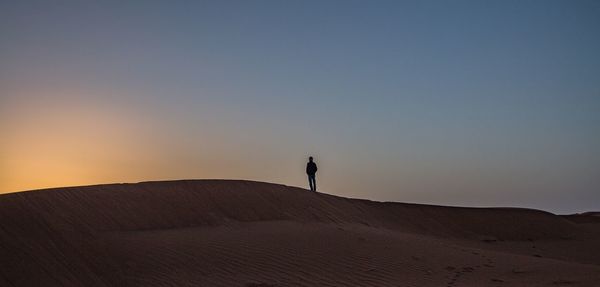 Scenic view of desert against sky during sunset