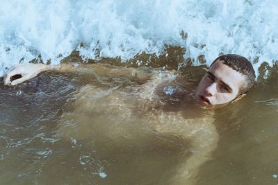 Portrait of man swimming in sea