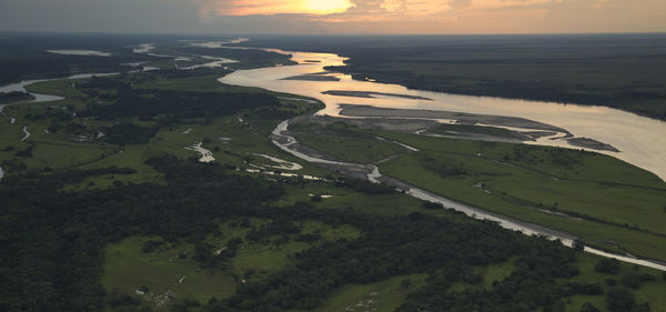 Panoramic shot of river against sky during sunset