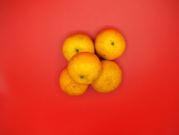 Close-up of fruits against orange background