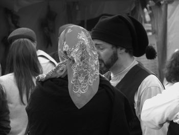 Close-up of friends standing against wall