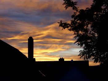 Silhouette of built structure against cloudy sky