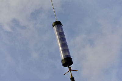 Low angle view of communications tower against sky