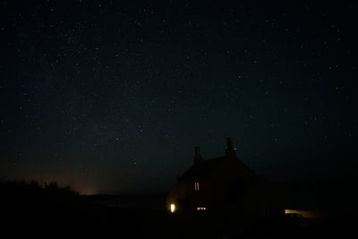 Low angle view of silhouette trees against sky at night