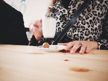 Midsection of woman drinking coffee