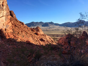 Scenic view of mountains against blue sky