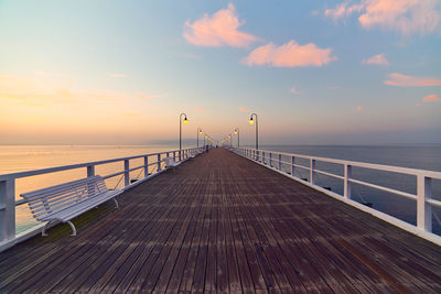 Pier on sea at sunset