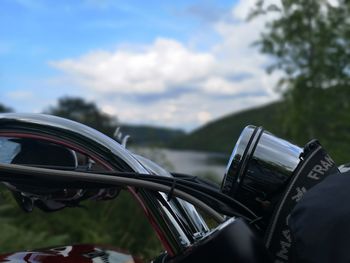 Close-up of vintage car on road against sky