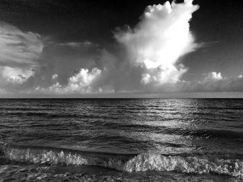 Scenic view of sea against cloudy sky