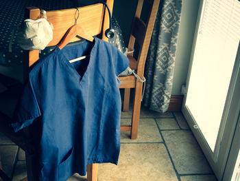 High angle view of man hanging on seat at home