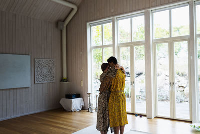 Couple hugging in yoga studio