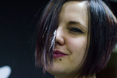 Portrait of smiling woman with icing on hair