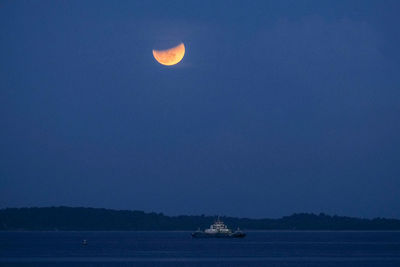 Scenic view of sea against clear sky at night
