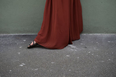 Low section of woman standing on road