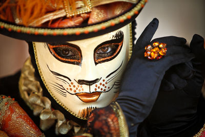 Portrait of person wearing venetian mask 