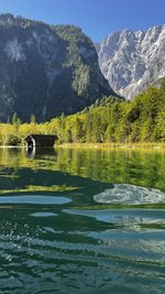 Scenic view of lake and mountains against sky