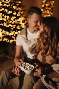 A happy couple in love celebrates the new year on christmas holidays at home at night indoors