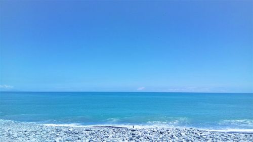 Scenic view of sea against clear blue sky
