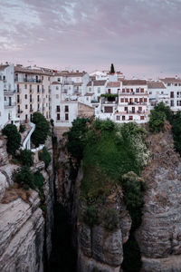 Buildings in city against cloudy sky