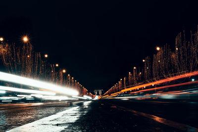 Cars on illuminated bridge at night