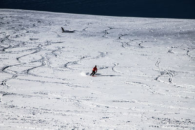 High angle view of person on snow covered field