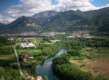 Scenic view of river and mountains against sky