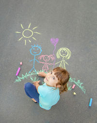 Girl drawing on road