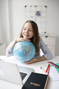 Cute girl looking at laptop at home