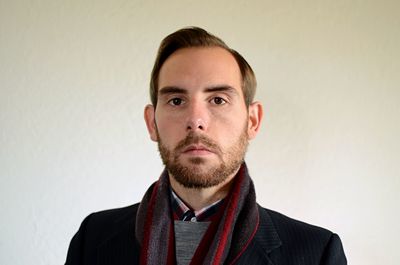 Close-up portrait of man against wall