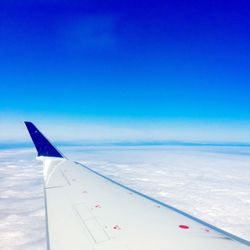 Cropped image of airplane over sea