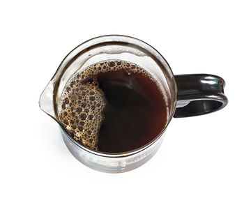 High angle view of coffee cup against white background