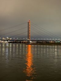 Bridge over river against sky in city