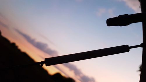 Low angle view of silhouette person against sky during sunset