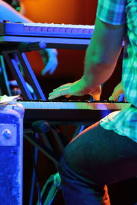 Cropped image of man playing piano at concert